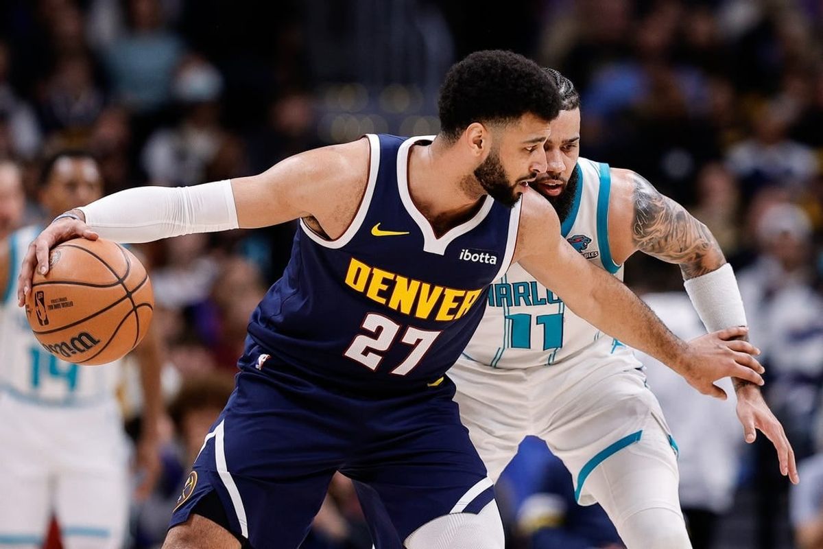 Jan 1, 2024; Denver, Colorado, USA; Denver Nuggets guard Jamal Murray (27) controls the ball against Charlotte Hornets forward Cody Martin (11) in the second quarter at Ball Arena.