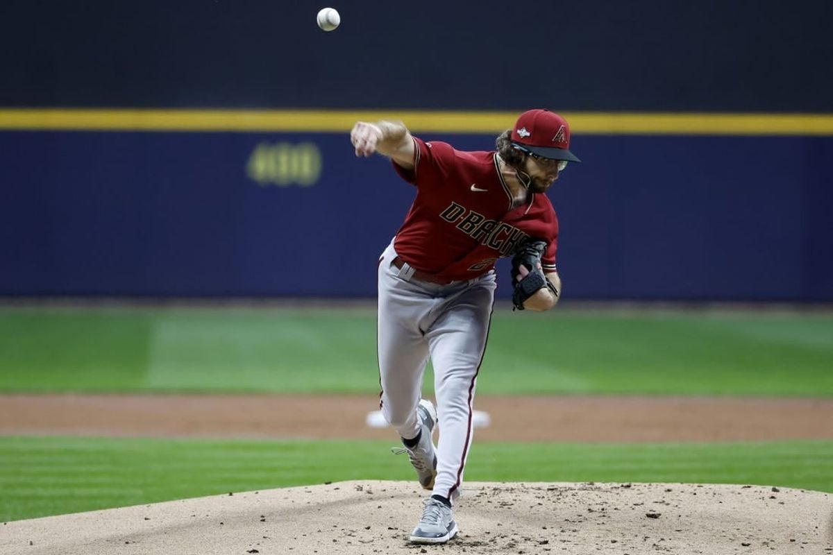 Oct 4, 2023; Milwaukee, Wisconsin, USA; Arizona Diamondbacks starting pitcher Zac Gallen (23) pitches against the Milwaukee Brewers in the first inning during game two of the Wildcard series for the 2023 MLB playoffs at American Family Field.