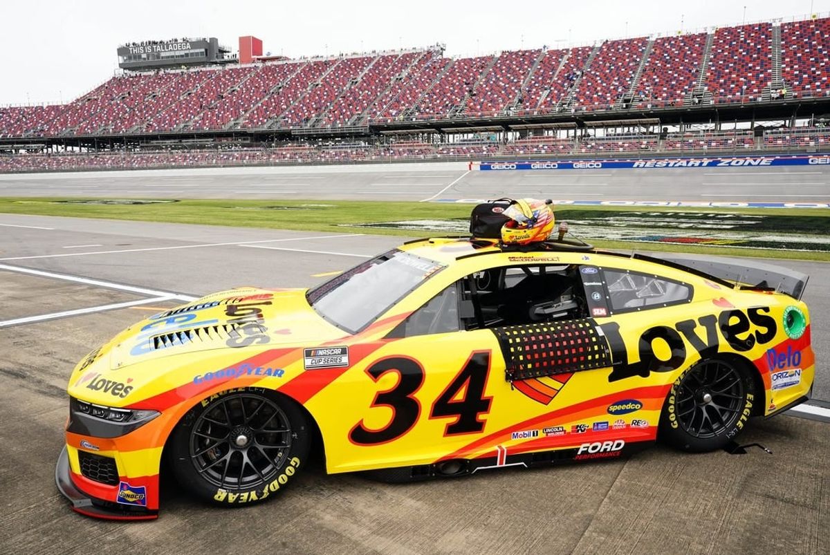 Apr 20, 2024; Talladega, Alabama, USA; NASCAR Cup Series driver Michael McDowell (34) Ford Mustang along pit road after setting the pole during qualifying for the Geico 500 at Talladega Superspeedway.