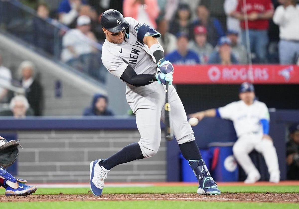 Apr 17, 2024; Toronto, Ontario, CAN; New York Yankees centre fielder Aaron Judge (99) hits a two run single against the Toronto Blue Jays during the ninth inning at Rogers Centre.