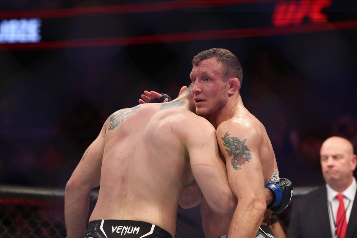 Dec 3, 2022; Orlando, Florida, USA; Jack Hermansson (red gloves) hugs Roman Dolidze (blue gloves) after the fight during UFC Fight Night at Amway Center.