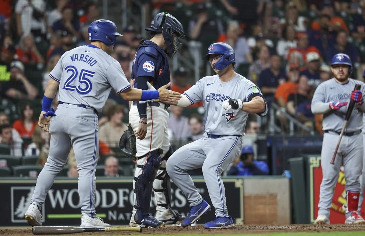 Apr 2, 2024; Houston, Texas, USA; Toronto Blue Jays left fielder Davis Schneider (36) celebrates with left fielder Daulton Varsho (25) after hitting a home run during the ninth inning against the Houston Astros at Minute Maid Park.