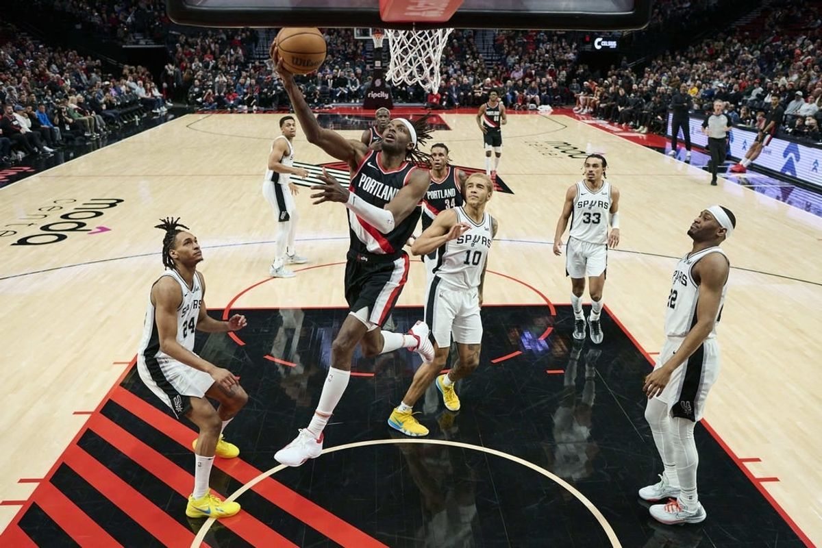 Dec 28, 2023; Portland, Oregon, USA; Portland Trail Blazers forward Jerami Grant (9) scores a basket during the second half against San Antonio Spurs forward Jeremy Sochan (10) at Moda Center.