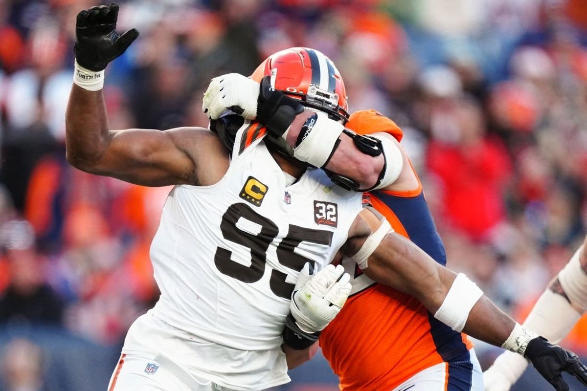 Nov 26, 2023; Denver, Colorado, USA; Denver Broncos offensive tackle Garett Bolles (72) holds Cleveland Browns defensive end Myles Garrett (95) in the second quarter at Empower Field at Mile High.