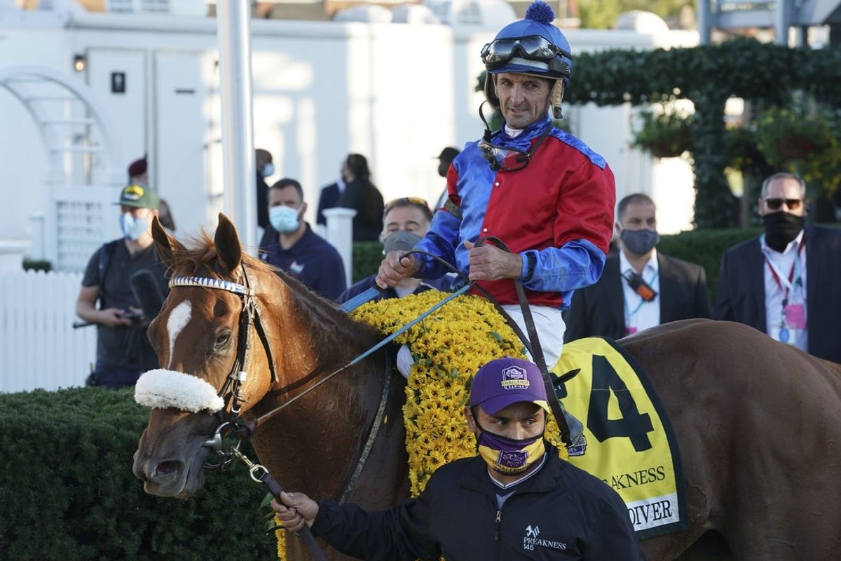 Oct 3, 2020; Baltimore, Maryland, USA; Robby Albarado aboard Swiss Skydiver (4) stands in the winner circle after winning the 145 Preakness Stakes at Pimlico Race Course. Mandatory Credit: Mitch Stringer-Imagn Images