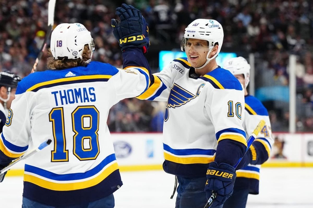 Nov 11, 2023; Denver, Colorado, USA; St. Louis Blues center Brayden Schenn (10) celebrates his hat trick goal with center Robert Thomas (18) in the third period against the Colorado Avalanche at Ball Arena.