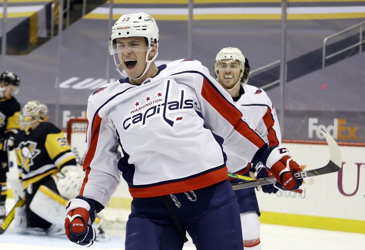 Feb 14, 2021; Pittsburgh, Pennsylvania, USA;  Washington Capitals left wing Jakub Vrana (13) reacts after scoring a goal against Pittsburgh Penguins goaltender Tristan Jarry (35) during the second period at PPG Paints Arena. Mandatory Credit: Charles LeClaire-Imagn Images