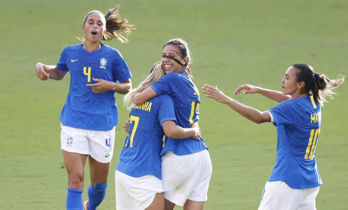 Feb 24, 2021; Orlando, Florida, USA; Brazil midfielder Andressinha (17) celebrates a goal by midfielder Julia (13) as midfielder Marta (10) and defender Rafaelle (4) rush in during a She Believes Cup soccer match against Canada at Exploria Stadium. Mandatory Credit: Reinhold Matay-USA TODAY Sports