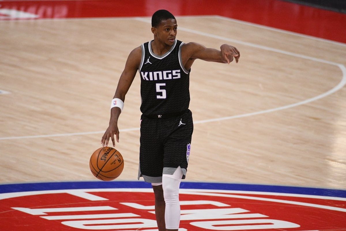 Feb 26, 2021; Detroit, Michigan, USA; Sacramento Kings guard De   Aaron Fox (5) brings the ball up court against the Detroit Pistons during the fourth quarter at Little Caesars Arena. Mandatory Credit: Tim Fuller-Imagn Images
