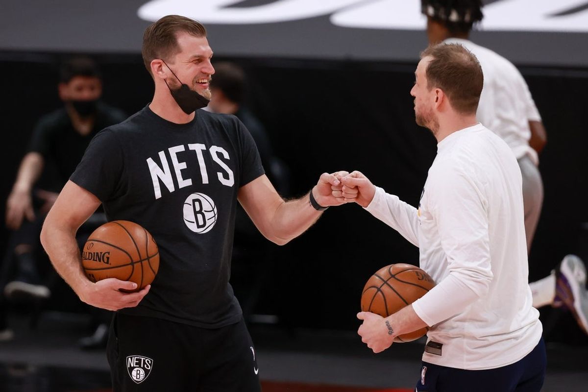 Mar 24, 2021; Salt Lake City, Utah, USA; Brooklyn Nets assistant coach Tiago Splitter and Utah Jazz guard Joe Ingles (2) bump fists before the game at Vivint Smart Home Arena. Mandatory Credit: Chris Nicoll-Imagn Images