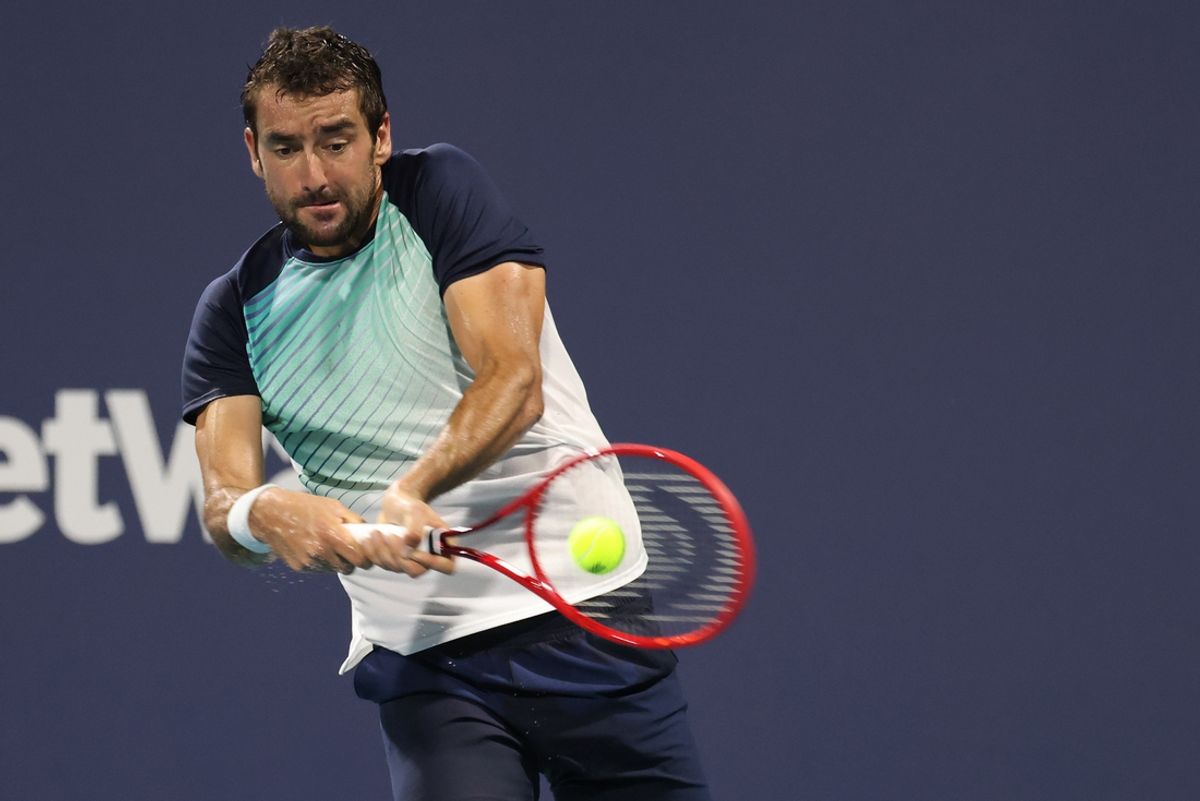 Mar 30, 2021; Miami, Florida, USA; Marin Cilic of Croatia hits a backhand against Andrey Rublev of Russia (not pictured) in the fourth round in the Miami Open at Hard Rock Stadium. Mandatory Credit: Geoff Burke-Imagn Images