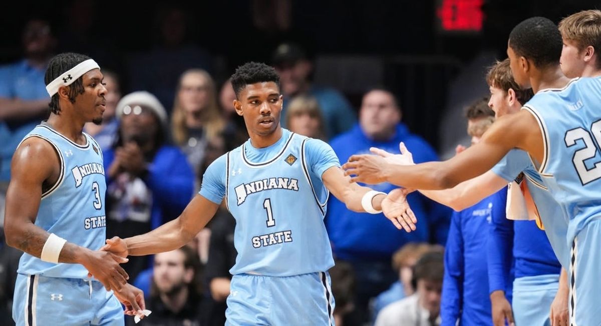 Indiana State Sycamores guard Julian Larry (1) high-fives Indiana State Sycamores guard Ryan Conwell (3) and other teammates on the sidelines Tuesday, April 2, 2024, during the NIT semifinals at Hinkle Fieldhouse in Indianapolis. The Indiana State Sycamores defeated the Utah Utes, 100-90.