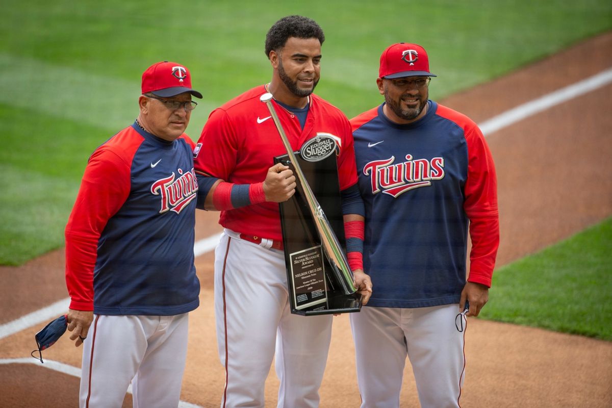 Apr 10, 2021; Minneapolis, Minnesota, USA; Minnesota Twins batting coaches Rudy Hernandez and Edgar Varela present the 2020 Silver Slugger Award to designated hitter Nelson Cruz (23) before the game with the Seattle Mariners at Target Field. Mandatory Credit: Bruce Kluckhohn-Imagn Images