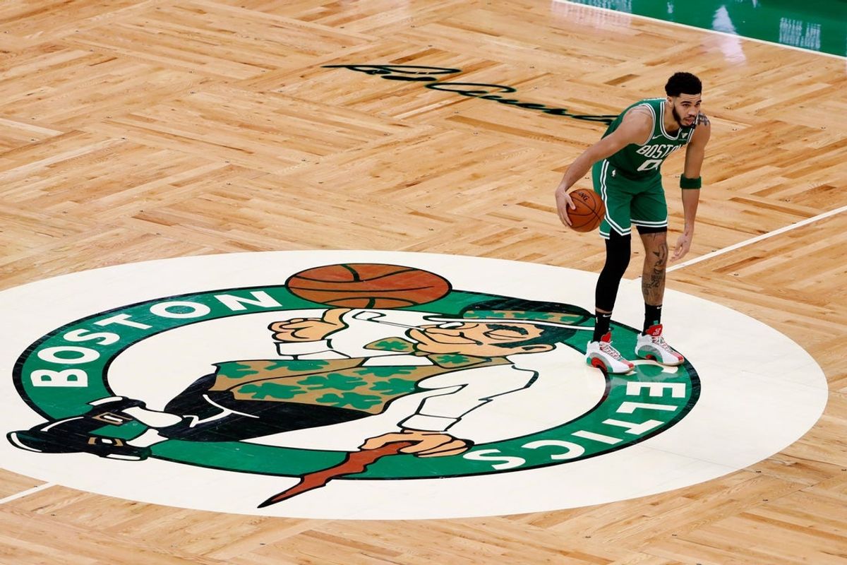 Apr 7, 2021; Boston, Massachusetts, USA; Boston Celtics forward Jayson Tatum (0) brings the ball up past half court over the Celtics logo during the third quarter against the New York Knicks at TD Garden. Mandatory Credit: Winslow Townson-Imagn Images