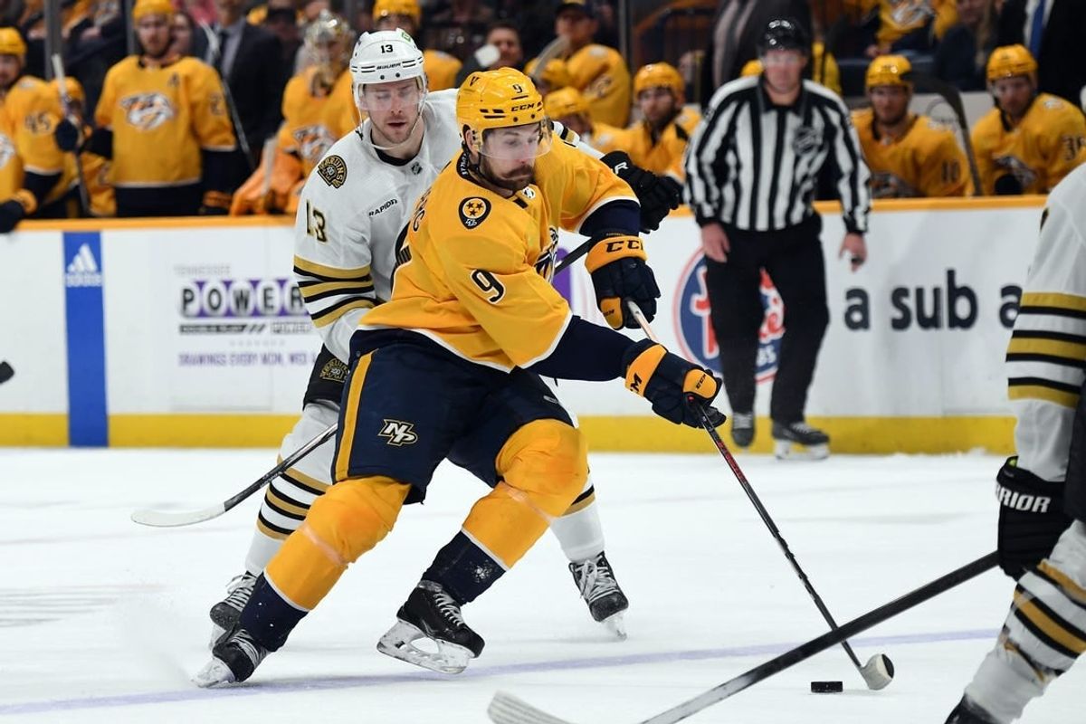 Apr 2, 2024; Nashville, Tennessee, USA; Nashville Predators left wing Filip Forsberg (9) skates the puck into the offensive zone during the third period against the Boston Bruins at Bridgestone Arena.