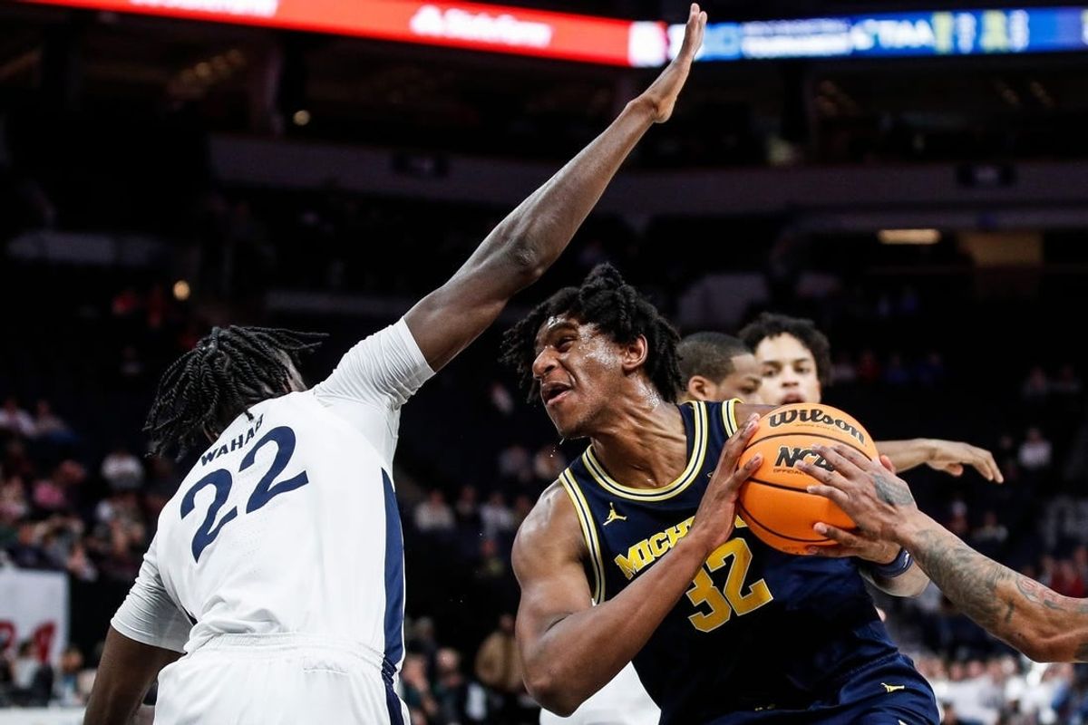 Michigan forward Tarris Reed Jr. (32) goes to the basket against Penn State forward Qudus Wahab (22) during the second half of the First Round of Big Ten tournament at Target Center in Minneapolis, Minn. on Wednesday, March 13, 2024.