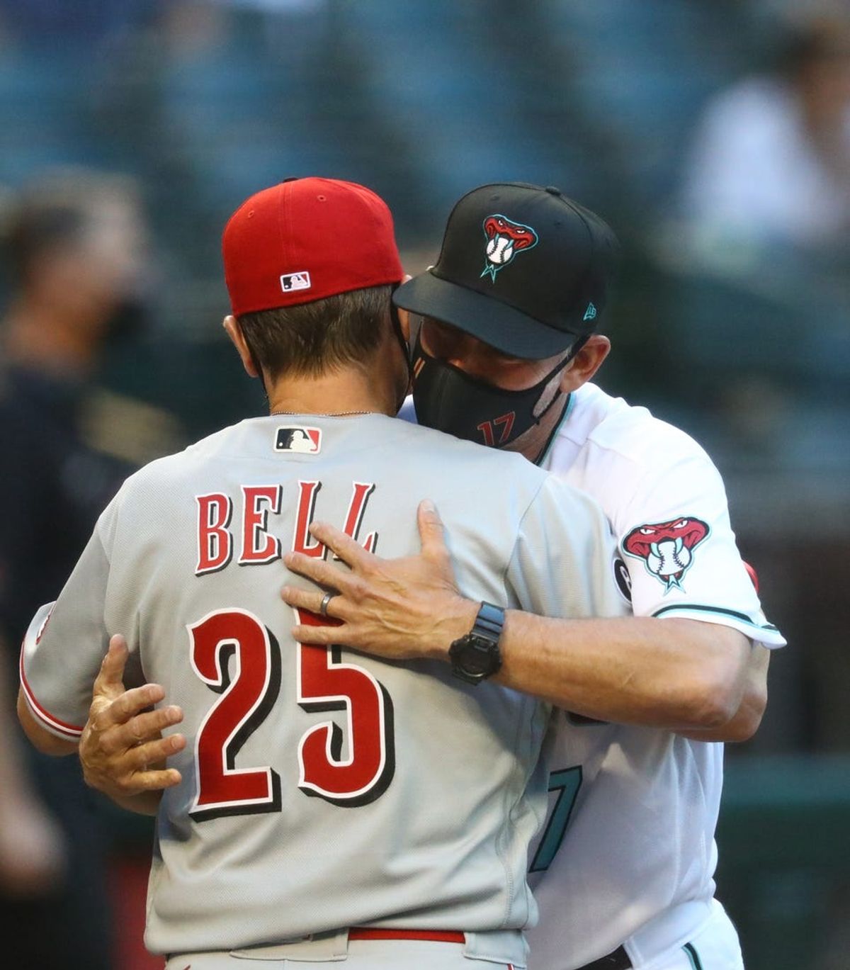 Apr 9, 2021; Phoenix, Arizona, USA; Arizona Diamondbacks manager Torey Lovullo (right) greets Cincinnati Reds manager David Bell during opening day at Chase Field. Mandatory Credit: Mark J. Rebilas-USA TODAY Sports