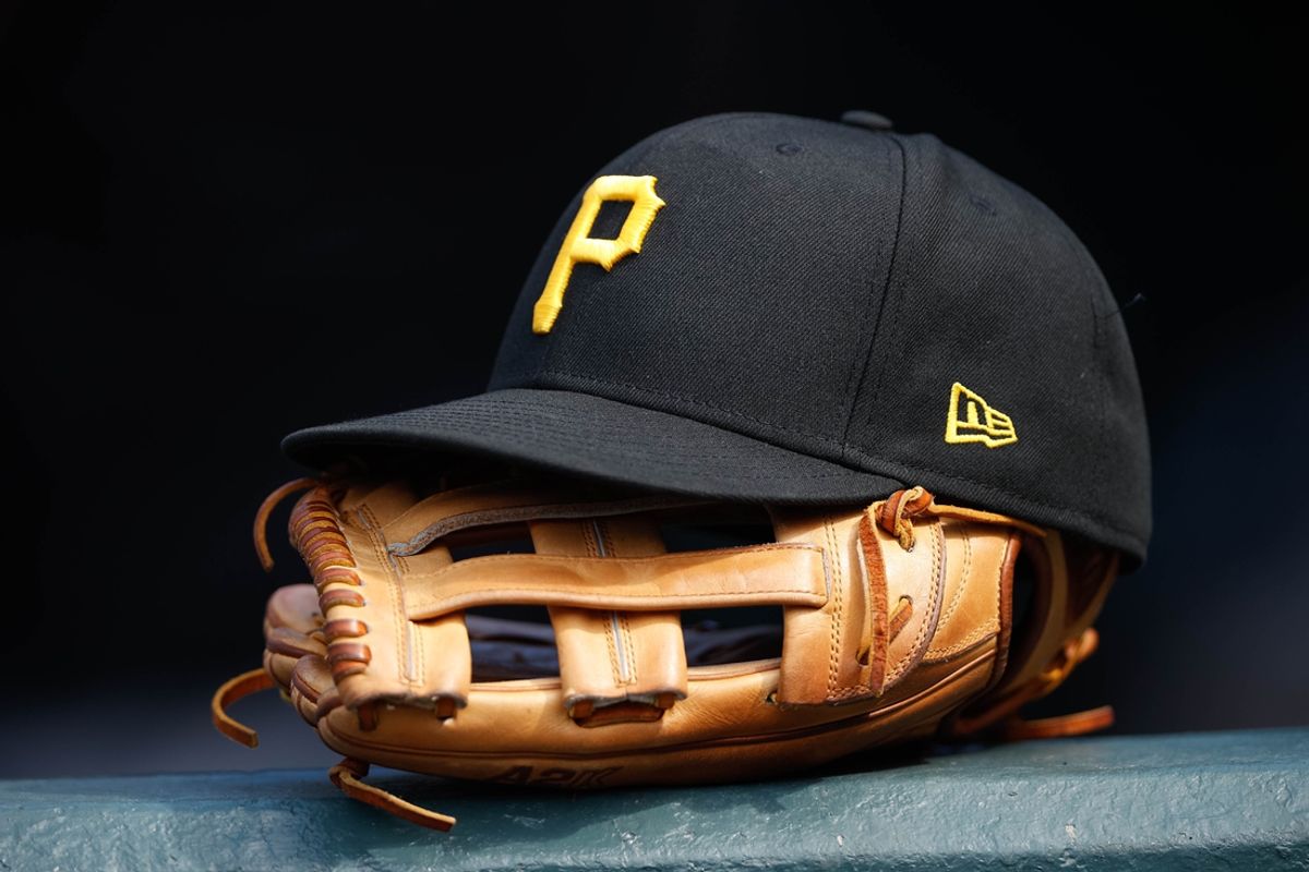 Jun 30, 2021; Denver, Colorado, USA; A general view of a Pittsburgh Pirates glove and hat in the eighth inning against the Colorado Rockies at Coors Field. Mandatory Credit: Isaiah J. Downing-Imagn Images