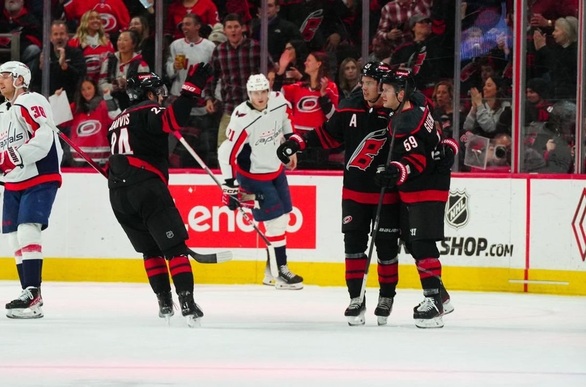 Apr 5, 2024; Raleigh, North Carolina, USA; Carolina Hurricanes center Jake Guentzel (59) is congratulated after his goal by center Sebastian Aho (20) and center Seth Jarvis (24) against the Washington Capitals during the second period at PNC Arena.