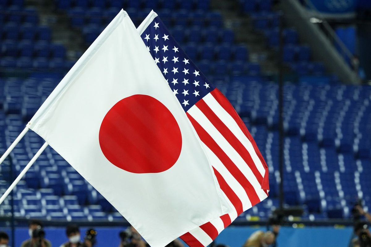 Jul 27, 2021; Yokohama, Japan; The flags of Japan and the United States of America are raised during the playing of the national anthems before the gold medal game in the Tokyo 2020 Olympic Summer Games at Yokohama Baseball Stadium. Mandatory Credit: Kareem Elgazzar-Imagn Images
