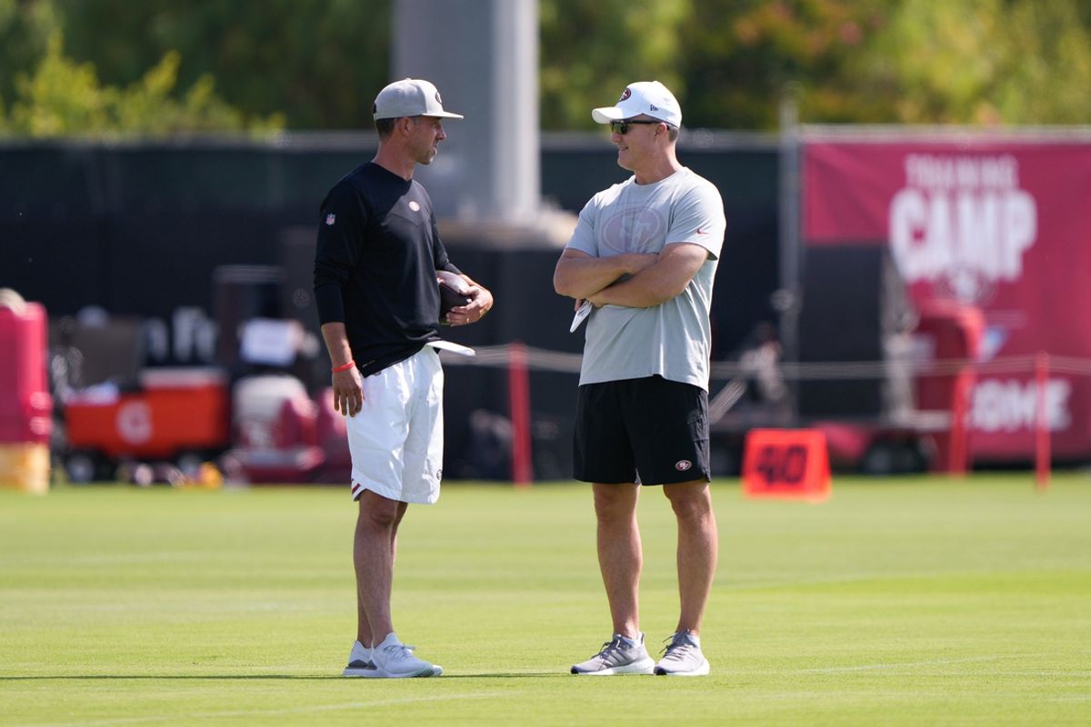 Jul 28, 2021; Santa Clara, CA, USA;  San Francisco 49ers head coach Kyle Shanahan (left) and general manager John Lynch during training camp at the SAP Performance Facility.  Mandatory Credit: Stan Szeto-Imagn Images