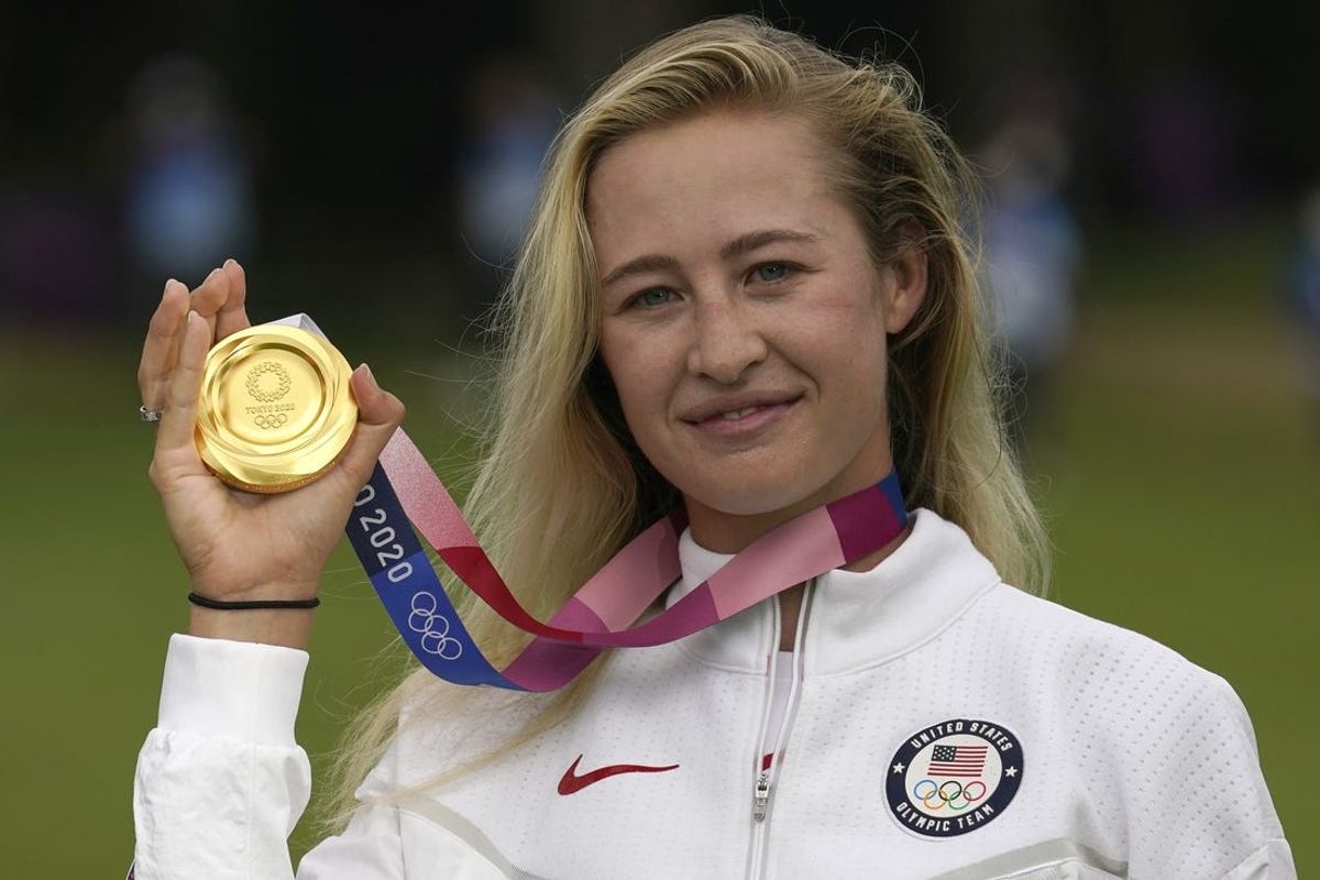 Aug 7, 2021; Tokyo, Japan; Nelly Korda (USA) celebrates with her gold medal on the podium after the final round of the women's individual stroke play of the Tokyo 2020 Olympic Summer Games at Kasumigaseki Country Club. Mandatory Credit: Michael Madrid-USA TODAY Sports