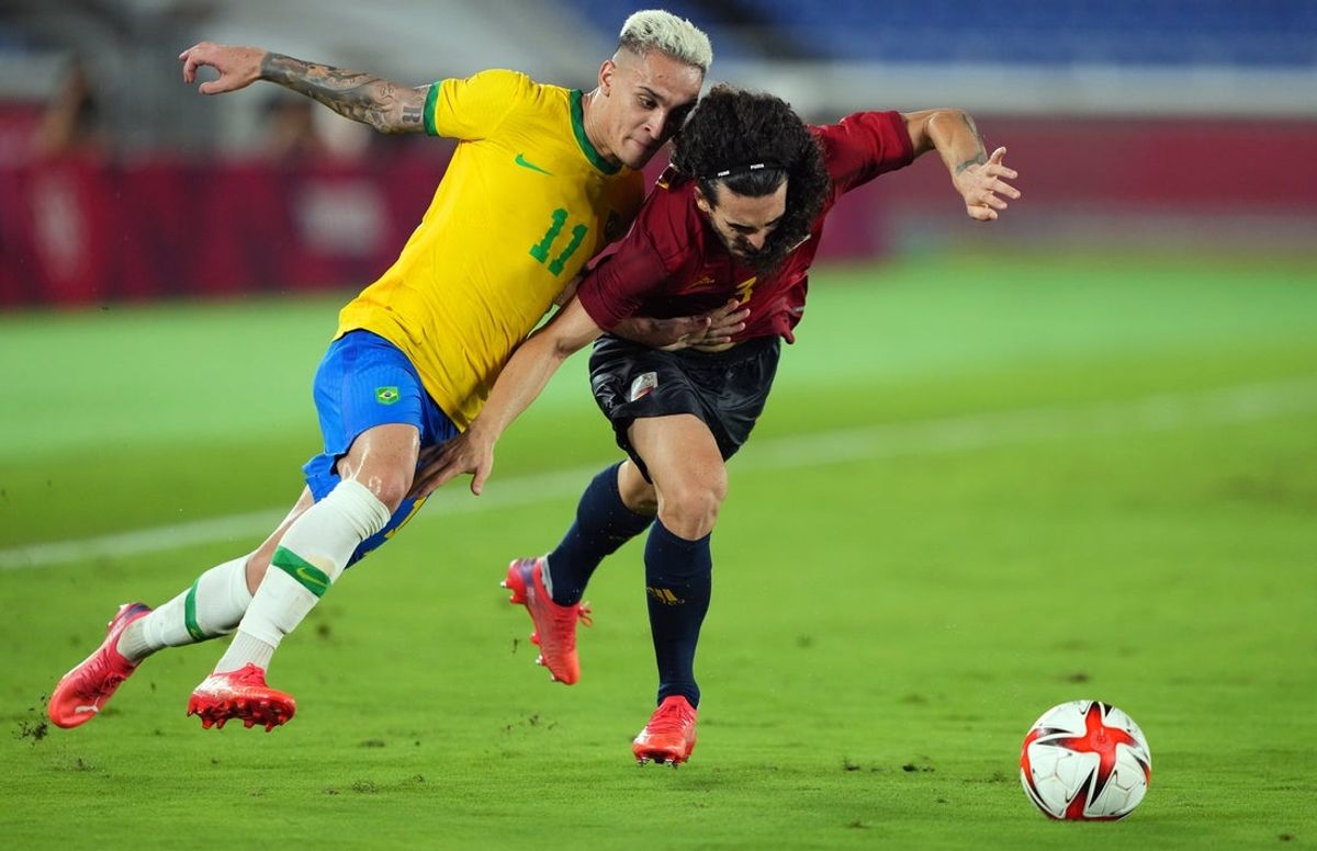Aug 7, 2021; Yokohama, Japan; Team Brazil forward Antony (11) battles for the ball against Team Spain defender Marc Cucurella (3) during the second half of the gold medal match in the Tokyo 2020 Olympic Summer Games at Nissan Stadium. Mandatory Credit: Kareem Elgazzar-Imagn Images