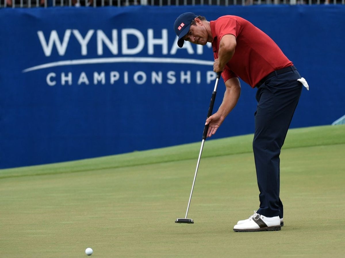 Aug 15, 2021; Greensboro, North Carolina, USA; Adam Scott putts on the ninth hole during the final round of the Wyndham Championship golf tournament. Mandatory Credit: Rob Kinnan-Imagn Images