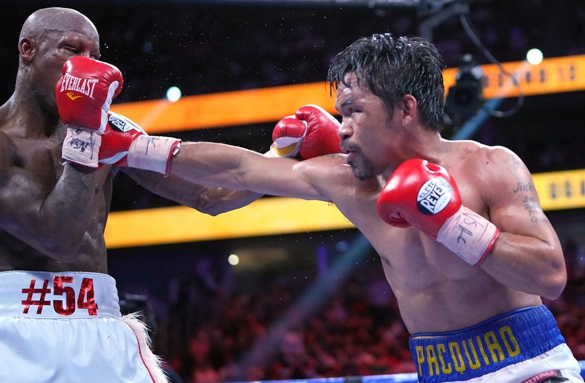 Aug 21, 2021; Las Vegas, Nevada; Manny Pacquiao (right) fights Yordenis Ugasin a world welterweight championship bout at T-Mobile Arena. Mandatory Credit: Stephen R. Sylvanie-Imagn Images