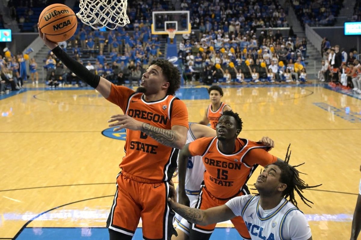 Feb 1, 2024; Los Angeles, California, USA; Oregon State Beavers guard Jordan Pope (0) scores past UCLA Bruins guard Brandon Williams (5) in the first half at Pauley Pavilion presented by Wescom.