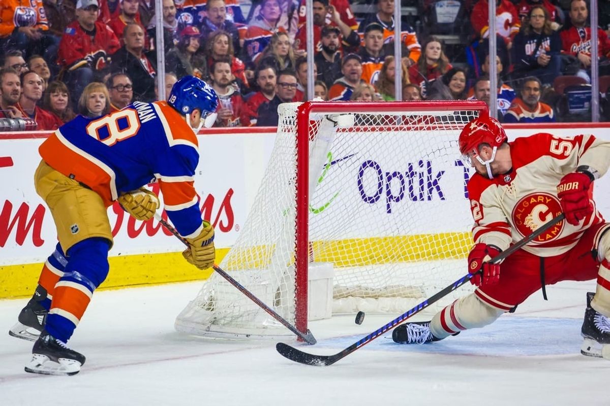 Jan 20, 2024; Calgary, Alberta, CAN; Edmonton Oilers left wing Zach Hyman (18) scores a goal as Calgary Flames defenseman MacKenzie Weegar (52) defends during the third period at Scotiabank Saddledome.