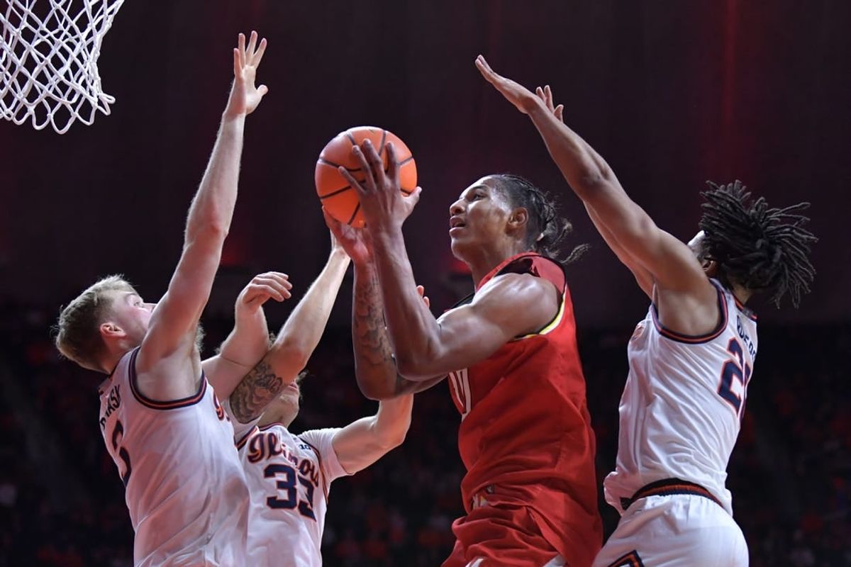 Jan 14, 2024; Champaign, Illinois, USA;  Maryland Terrapins forward Julian Reese (10) shoots the ball between Illinois Fighting Illini players in the second half at State Farm Center.