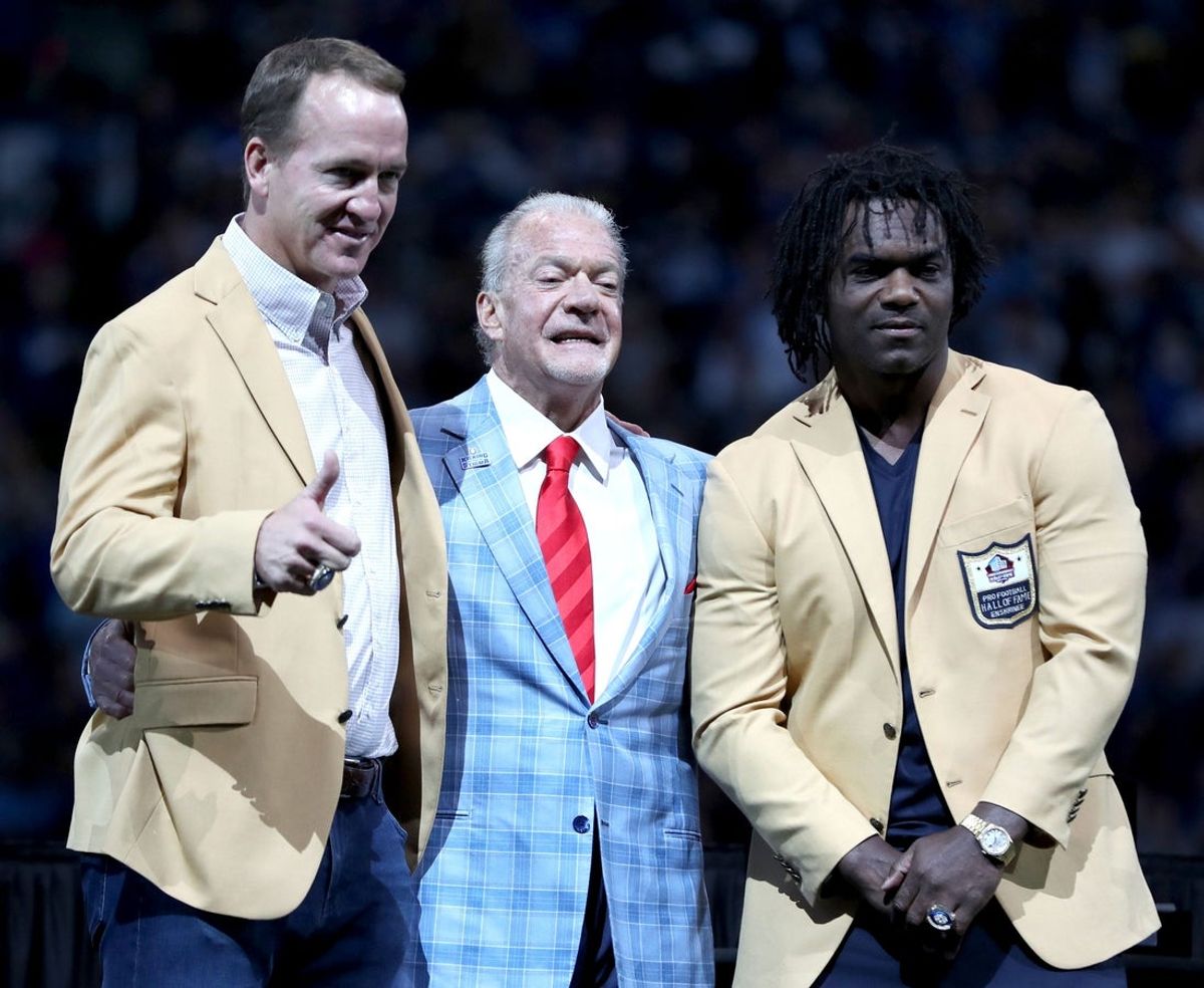 Peyton Manning and Edgerrin James stand with Jim Irsay after receiving their hall of fame rings Sunday, Sept. 19, 2021, during halftime of a game against the Los Angeles Rams at Lucas Oil Stadium in Indianapolis.