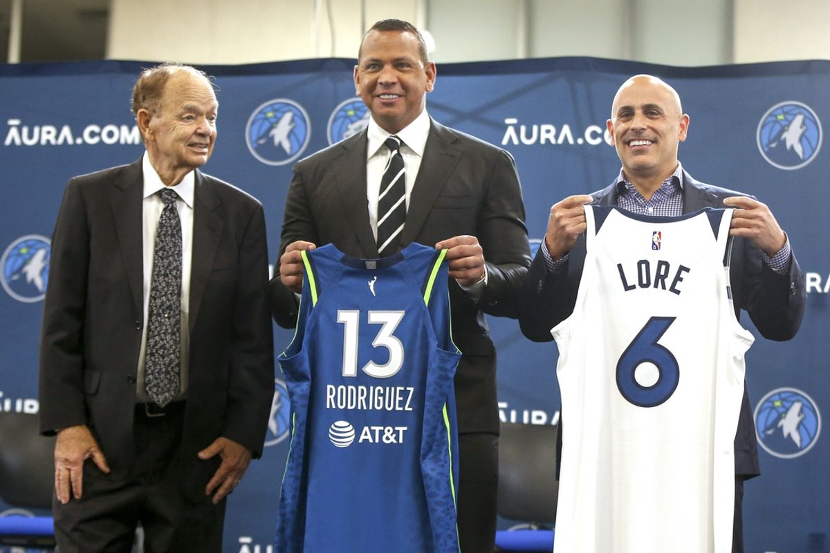 Sep 27, 2021; Minneapolis, MN, USA; Current owner Glen Taylor and limited partners and alt-governors for the Minnesota Timberwolves Alex Rodriguez and Mark Lore hold up jerseys after answering questions at a press conference at media day. Mandatory Credit: Bruce Kluckhohn-Imagn Images