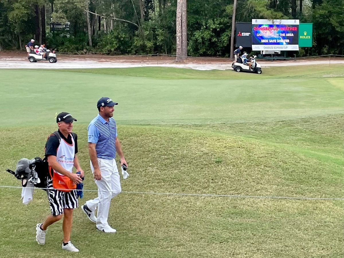 Keith Horne and his caddie walk past a sign warning fans of oncoming dangerous weather on Friday during the first round of the Constellation Furyk & Friends, at the Timuquana Country Club.

Weather