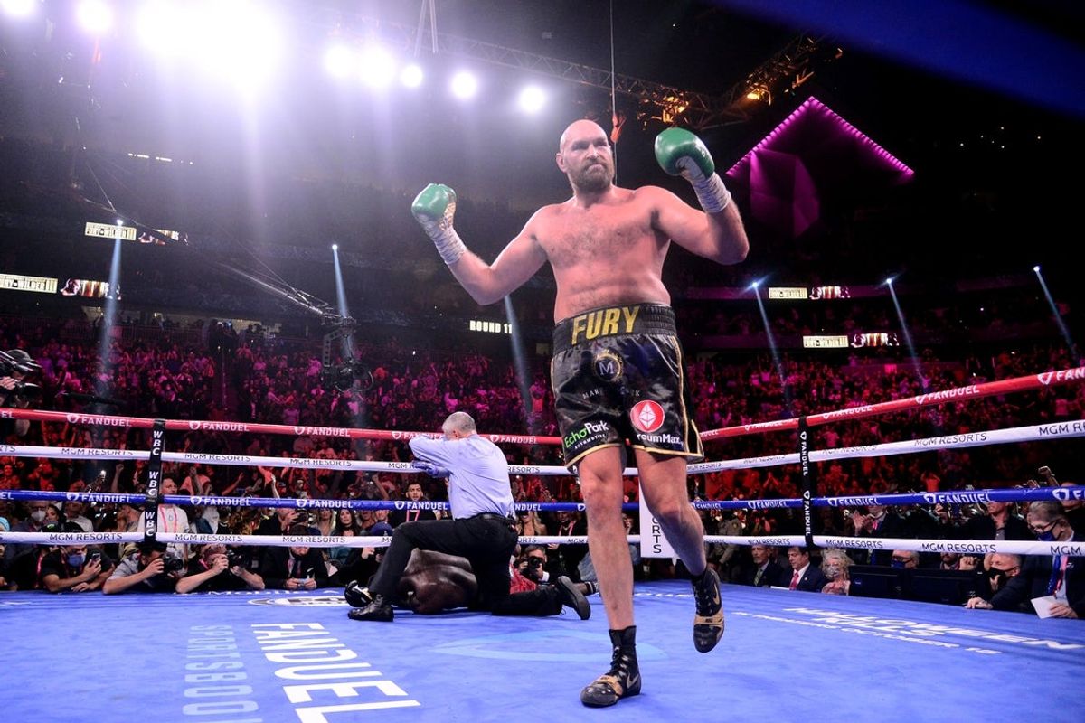 Oct 9, 2021; Las Vegas, Nevada, USA; Deontay Wilder (red/black trunks) is knocked out by Tyson Fury (black/gold trunks) during their WBC/Lineal heavyweight championship boxing match at T-Mobile Arena. Mandatory Credit: Joe Camporeale-Imagn Images