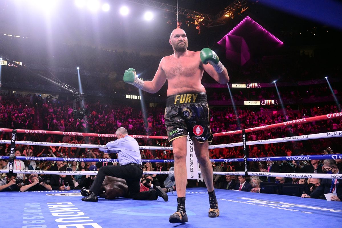 Oct 9, 2021; Las Vegas, Nevada, USA; Deontay Wilder (red/black trunks) is knocked out by Tyson Fury (black/gold trunks) during their WBC/Lineal heavyweight championship boxing match at T-Mobile Arena. Mandatory Credit: Joe Camporeale-Imagn Images