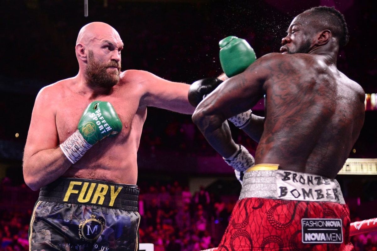 Oct 9, 2021; Las Vegas, Nevada, USA; Deontay Wilder (red/black trunks) and Tyson Fury (black/gold trunks) box during their WBC/Lineal heavyweight championship boxing match at T-Mobile Arena. Mandatory Credit: Joe Camporeale-Imagn Images