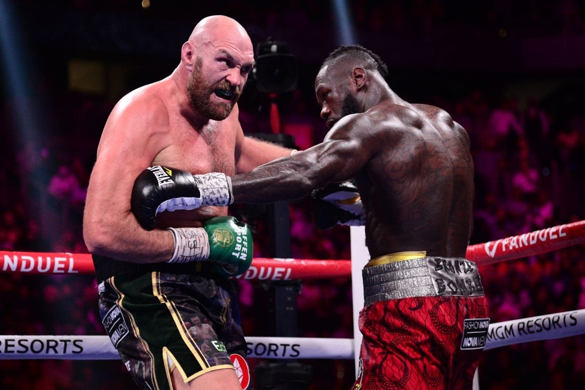 Oct 9, 2021; Las Vegas, Nevada, USA; Deontay Wilder (red/black trunks) and Tyson Fury (black/gold trunks) box during their WBC/Lineal heavyweight championship boxing match at T-Mobile Arena. Mandatory Credit: Joe Camporeale-Imagn Images