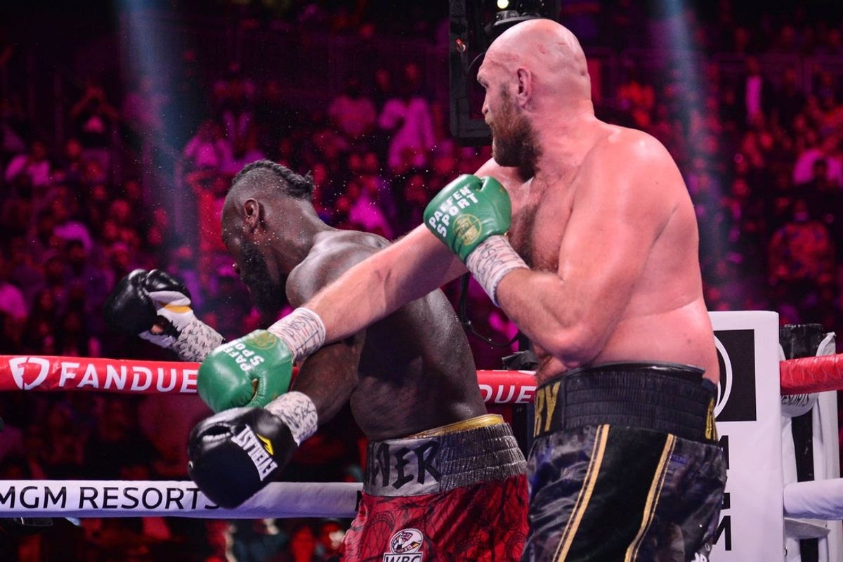 Oct 9, 2021; Las Vegas, Nevada, USA; Deontay Wilder (red/black trunks) is knocked out by Tyson Fury (black/gold trunks) during their WBC/Lineal heavyweight championship boxing match at T-Mobile Arena. Mandatory Credit: Joe Camporeale-Imagn Images