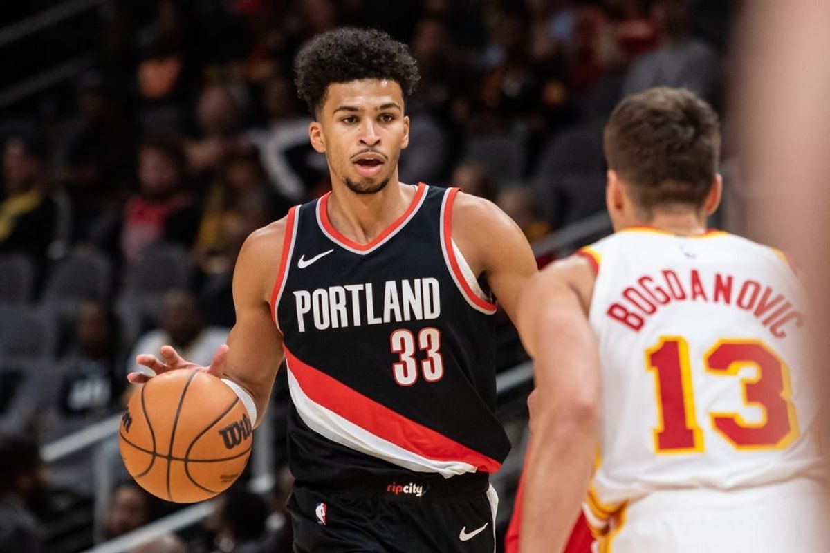 Mar 27, 2024; Atlanta, Georgia, USA; Portland Trail Blazers forward Toumani Camara (33) dribbles the ball against Atlanta Hawks guard Bogdan Bogdanovic (13) during the first quarter at State Farm Arena.