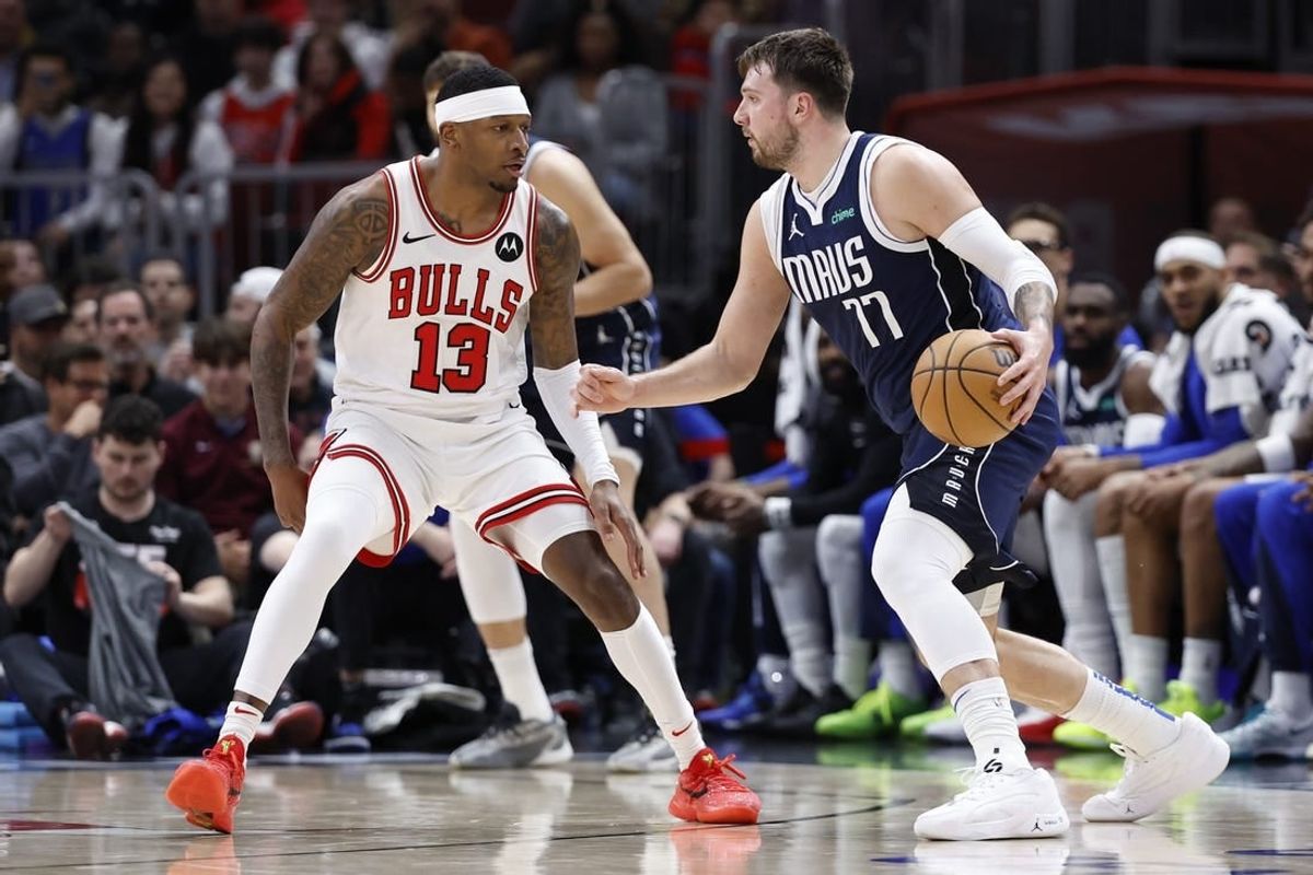 Mar 11, 2024; Chicago, Illinois, USA; Dallas Mavericks guard Luka Doncic (77) drives to the basket against Chicago Bulls forward Torrey Craig (13) during the first half at United Center.