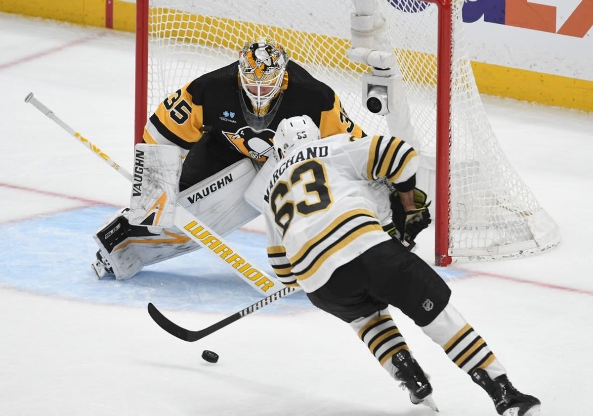 Apr 13, 2024; Pittsburgh, Pennsylvania, USA; Boston Bruins left wing Brad Marchand (63) scores on Pittsburgh Penguins goalie Tristan Jarry (35)  during the second period at PPG Paints Arena.