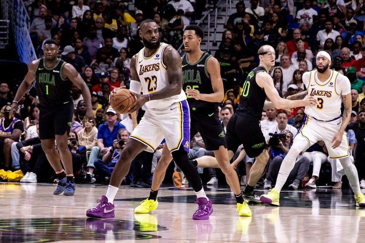 Apr 14, 2024; New Orleans, Louisiana, USA; Los Angeles Lakers forward LeBron James (23) looks to pass the ball against New Orleans Pelicans guard Trey Murphy III (25) during the first half at Smoothie King Center.