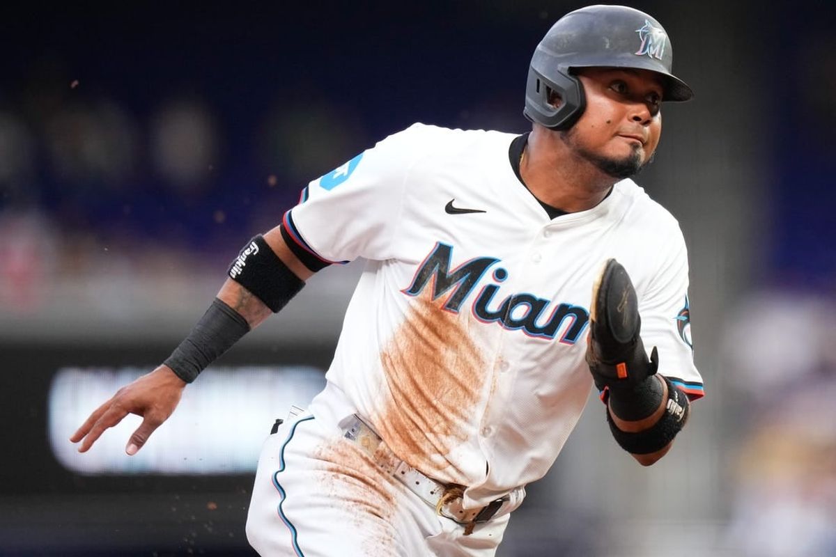 Apr 1, 2024; Miami, Florida, USA; Miami Marlins second baseman Luis Arraez (3) rounds third base to score against the Los Angeles Angels during the first inning at loanDepot Park.