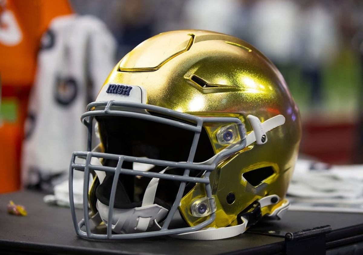 Jan 1, 2022; Glendale, Arizona, USA; Detailed view of a gold Notre Dame Fighting Irish helmet during the 2022 Fiesta Bowl at State Farm Stadium.