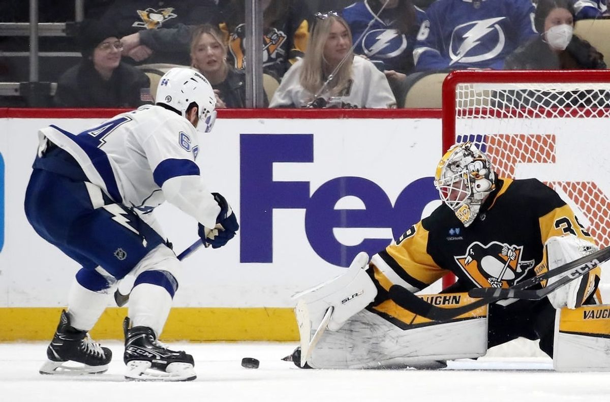 Apr 6, 2024; Pittsburgh, Pennsylvania, USA;  Pittsburgh Penguins goaltender Alex Nedeljkovic (39) makes a save against Tampa Bay Lightning center Tyler Motte (64) during the third period at PPG Paints Arena. The Penguins won 5-4.