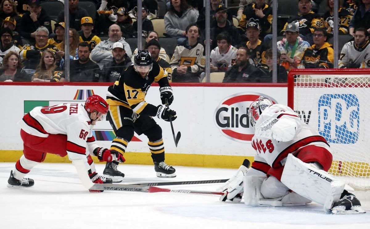 Mar 26, 2024; Pittsburgh, Pennsylvania, USA; Carolina Hurricanes left wing Jake Guentzel (59) and goaltender Pyotr Kochetkov (52) defend Pittsburgh Penguins right wing Bryan Rust (17) during the first period at PPG Paints Arena.