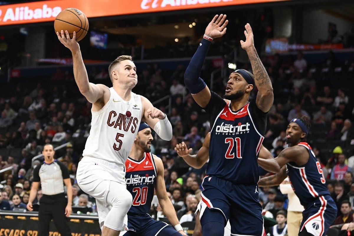 Feb 7, 2024; Washington, District of Columbia, USA; Cleveland Cavaliers guard Sam Merrill (5) prepares to shoot over Washington Wizards center Daniel Gafford (21) during the first half at Capital One Arena.