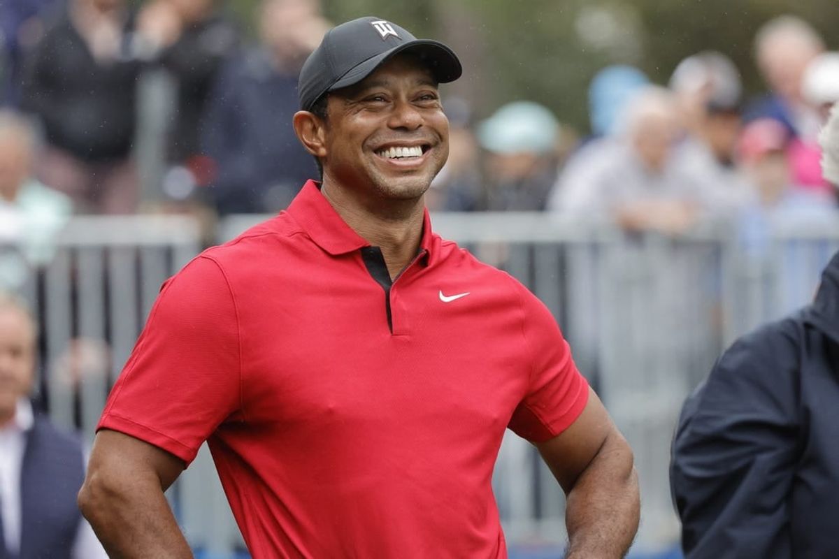 Dec 17, 2023; Orlando, Florida, USA;  Tiger Woods smiles before he plays his shot from the first tee during the PNC Championship at The Ritz-Carlton Golf Club.